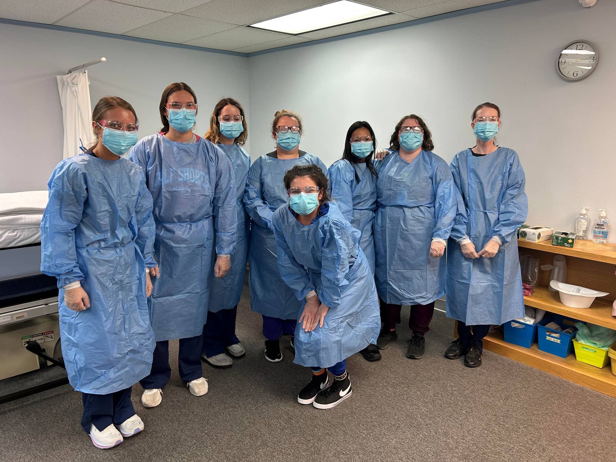 PAL CNA students in protective gowns in the skills lab